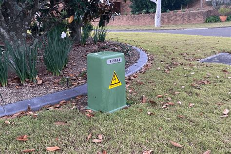 green electricity box|green box outside house.